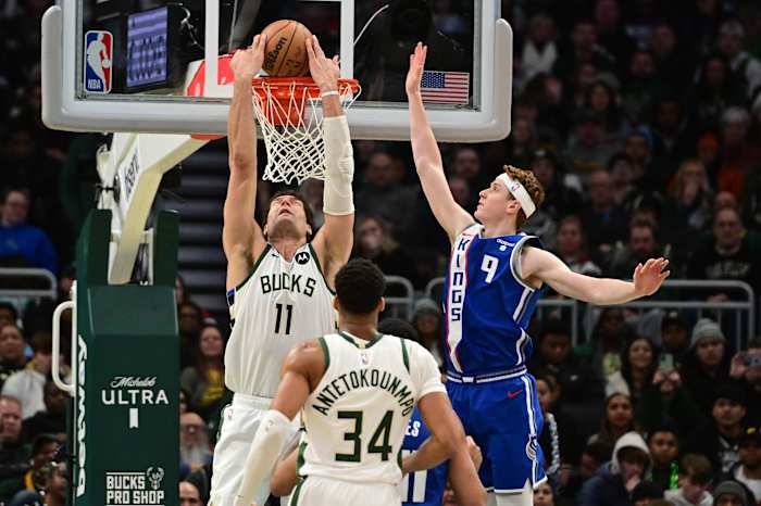 Milwaukee Bucks center Brook Lopez (11) reverse dunks the ball against Sacramento Kings guard Kevin Huerter (9) i
